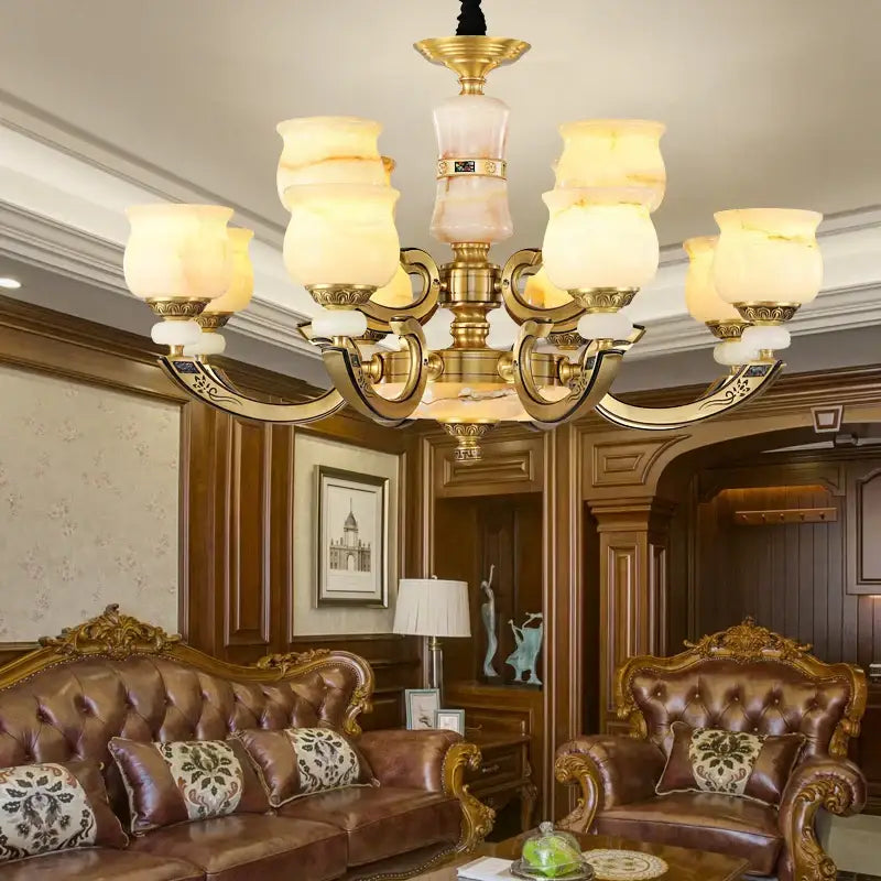 Gold-toned copper jade pendant lamp with ornate metal arms and warm frosted glass shades for dining room decorbites decor
