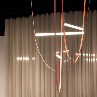 Modern copper leather bell pendant light with sleek orange straps and illuminated white LED bars for pendant light decorbites bell pendant