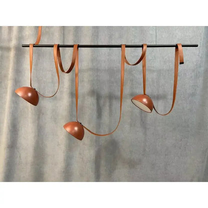 Modern copper led belt chandelier pendant light with sleek leather straps hanging from a black rod for living room decorbites led belt