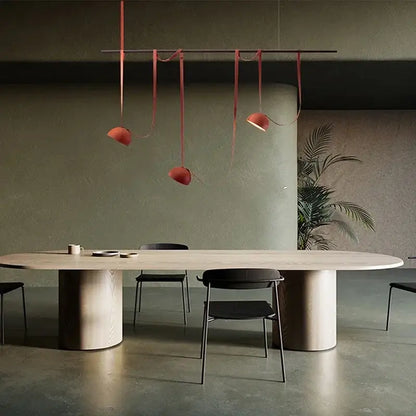 Modern minimalist dining table with light wood top and concrete legs under a modern copper led belt chandelier pendant light decorbites led belt
