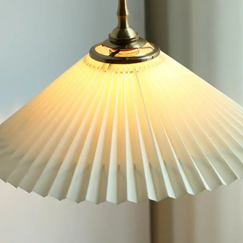 A warm cream-colored pleated paper pendant lamp with brass fixture for decorbites copper led pendant lighting