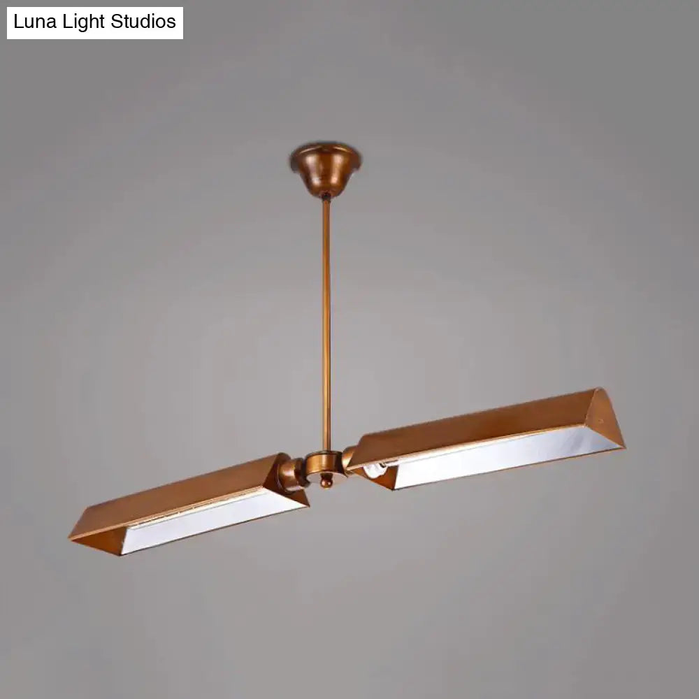 Brass-finished modern copper metal triangle island pendant light with two angular rectangular lamp heads on a central rod