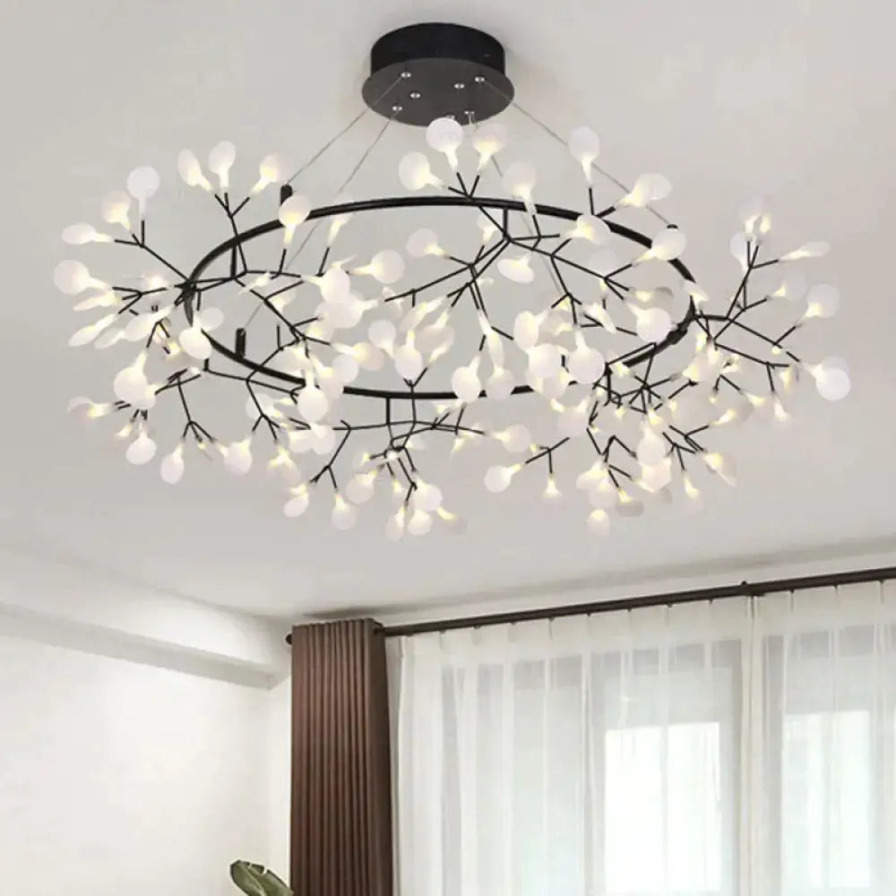 Modern black metal pendant light with delicate white leaf-shaped fixtures in a circular tree branch design for dining room