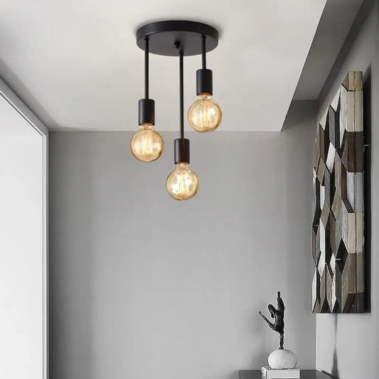 Black metal pendant light with three edison bulbs featuring modern country style and metal construction for kitchen use