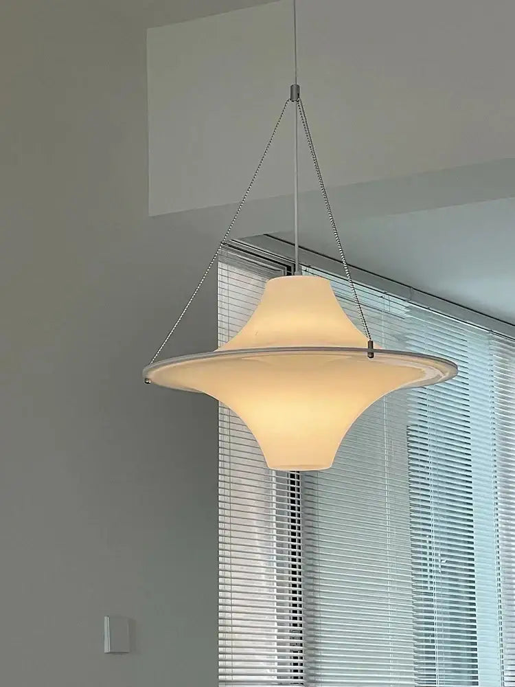 Modern cream acrylic ufo pendant light with warm-toned flared glass shade suspended by metal chains for dining room decorbites cream acrylic