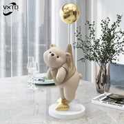 Modern cream and gold balloon polar bear resin figurine with reflective golden balloon on white circular base for office decor