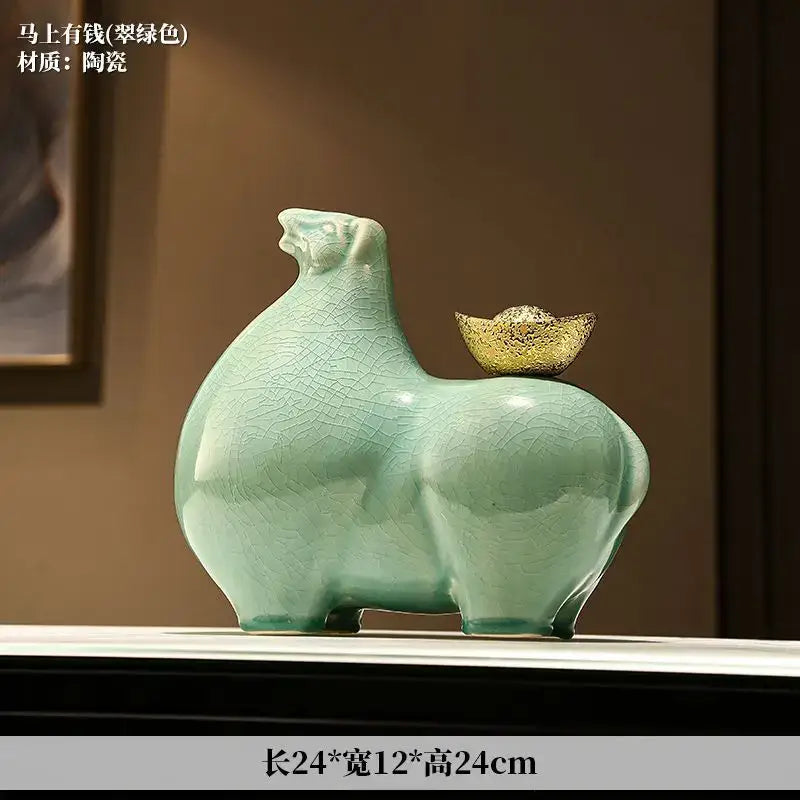 Ceramic green pig figurine with gold coin on back shown alongside modern cream and gold horse sculpture figurine decorbites horse sculpture
