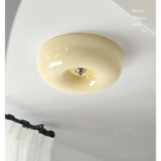 Modern cream bauhaus style ceiling lamp with glossy ceramic finish and metallic center fixture for bedroom decorbites decor
