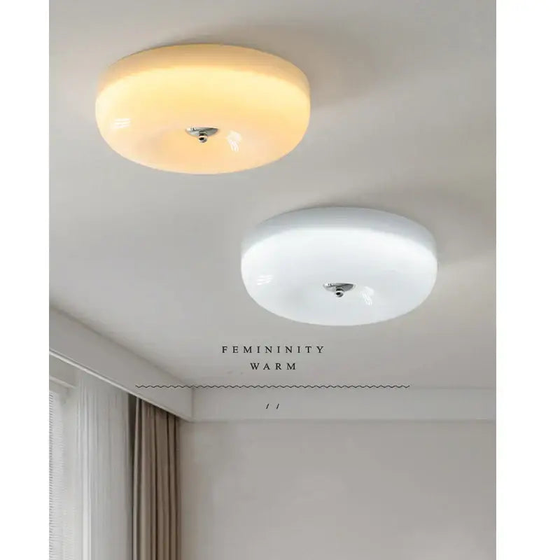 Two circular ceiling lamps with frosted glass and chrome in decorbites cream bauhaus style for bedroom decor