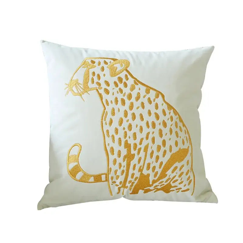 White throw pillow with embroidered gold leopard design in cream and black for modern home decor and bedroom use