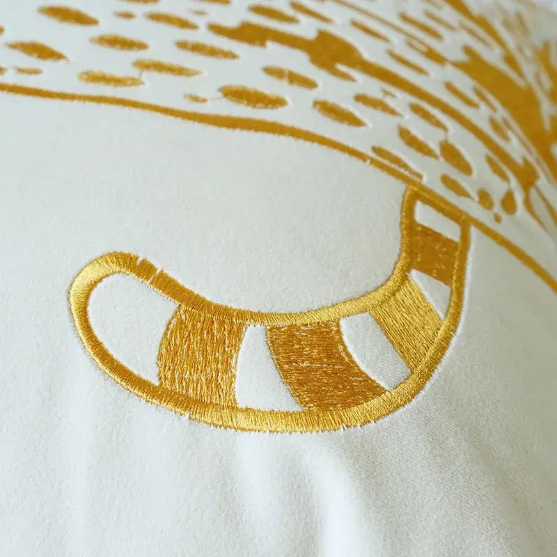 A golden embroidered cat tail with gold thread stripes on white fabric for modern cream and black embroidered leopard pillowcase home decor