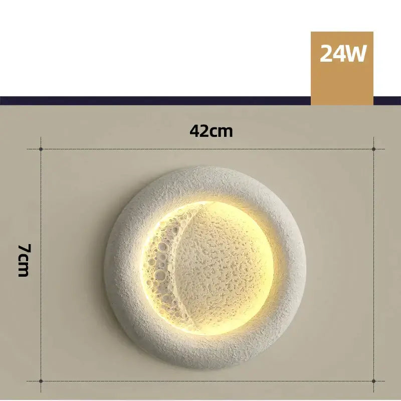 A modern circular cream breeze moon ceiling lamp with textured white concrete finish and warm illuminated crescent design