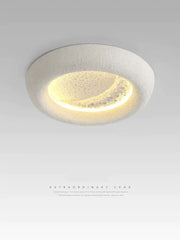 A modern cream breeze moon ceiling lamp with a textured white ring and warm yellow crescent light for bedroom decorbites