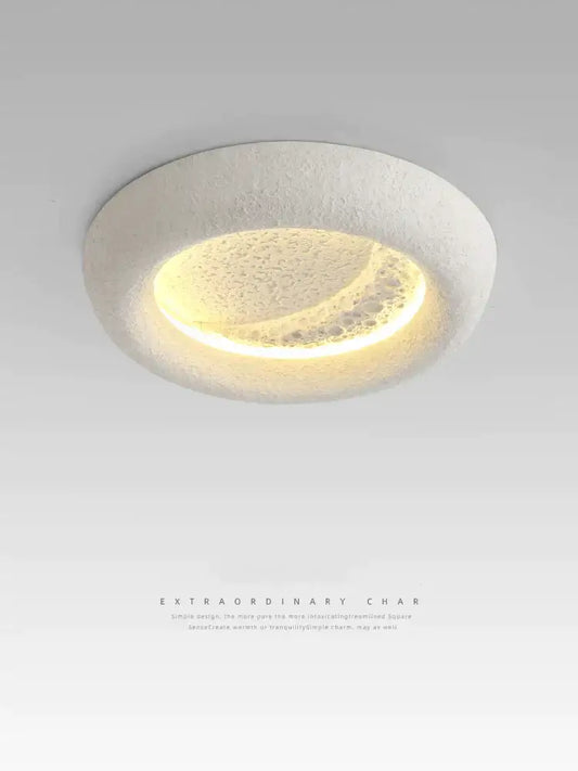 A modern cream breeze moon ceiling lamp with a textured white ring and warm yellow crescent light for bedroom decorbites