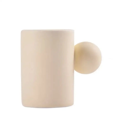 Modern cream ceramic cup with spherical handle and matching saucer set ideal for decorbites cotton candy dining room use