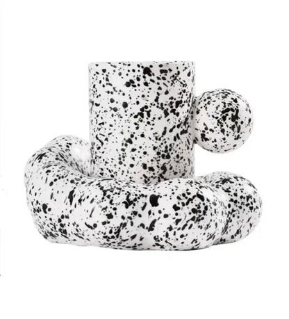 Modern cream ceramic cup and saucer set with white ceramic candle holder featuring black speckled texture and handles decorbites cotton candy