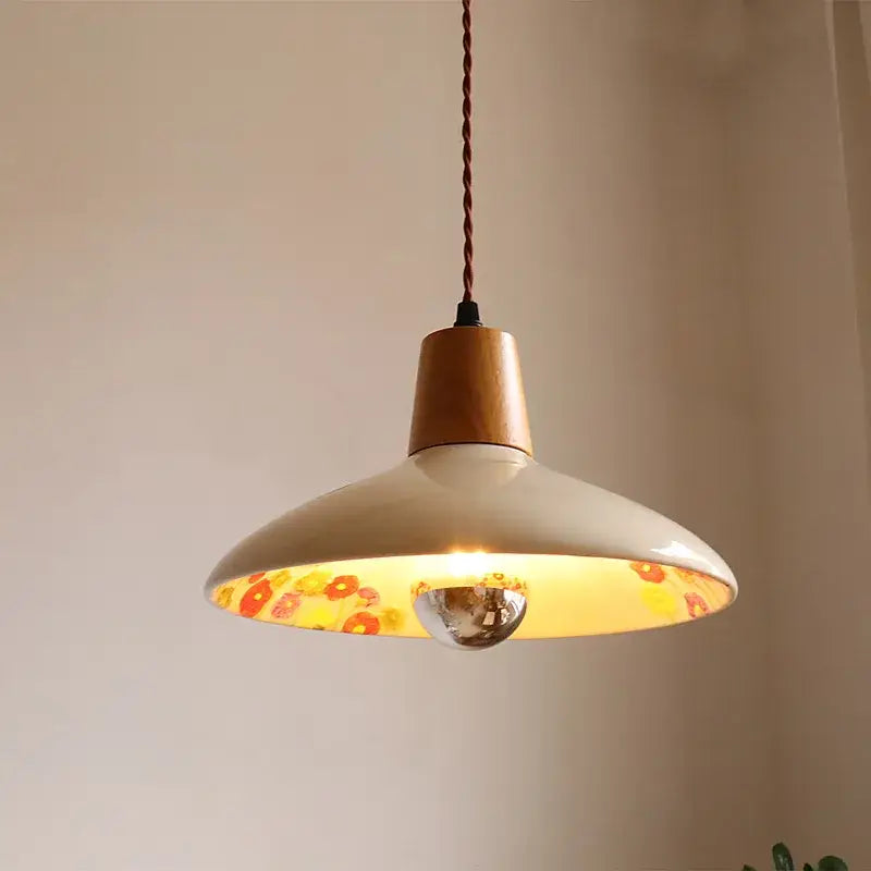 Modern cream ceramic led pendant light with wooden top floral interior and twisted brown cord by decorbites ceramic led pendant