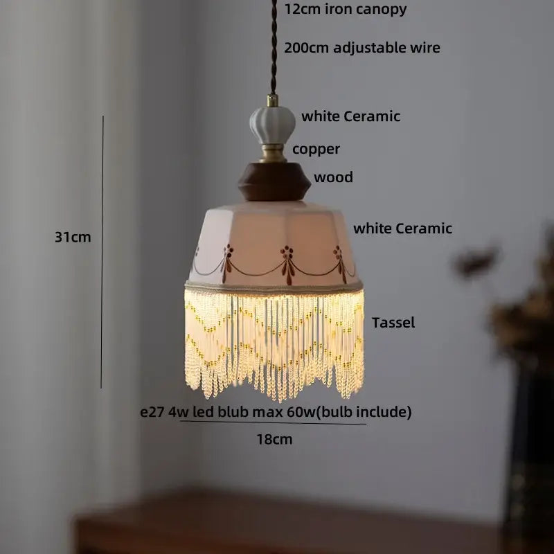 Modern cream ceramic led pendant light with peach ceramic led pendant, wooden base, copper accents, and crystal tassels