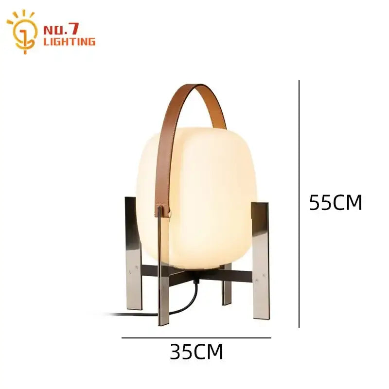 A modern cream designer metal glass table lamp with frosted shade and brown leather handle for bedroom decorbites designer metal