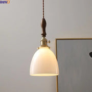 Modern cream glass copper led pendant light with warm tone, dark wood handle, and brass hardware for dining room