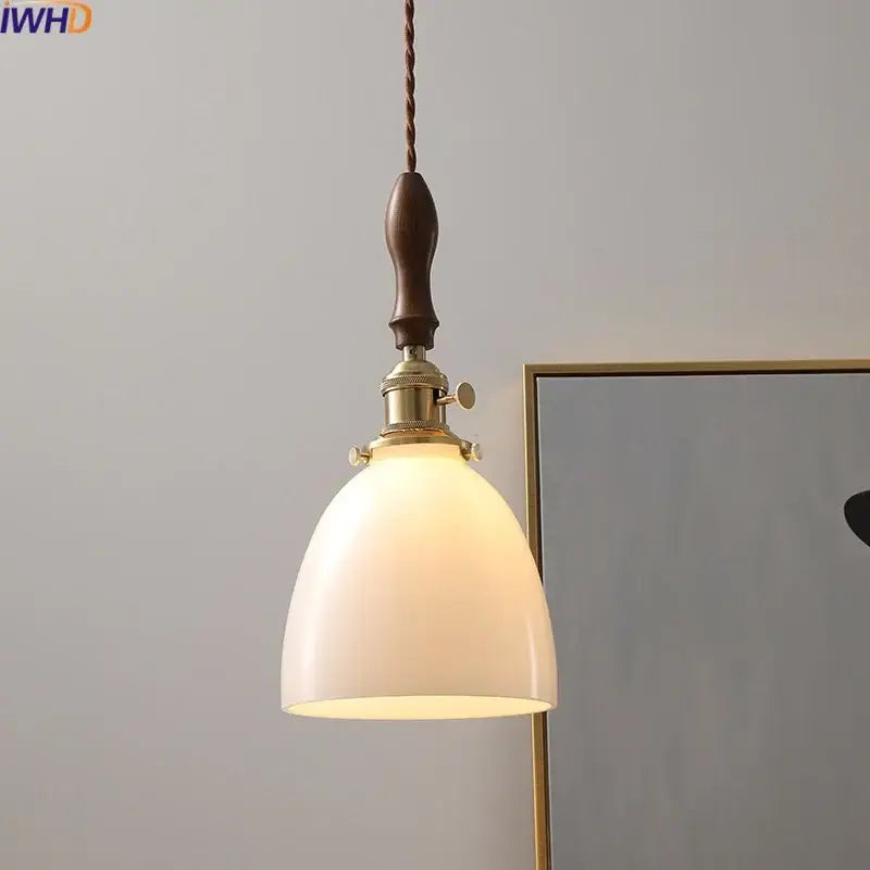 Modern cream glass copper led pendant light with warm tone, dark wood handle, and brass hardware for dining room