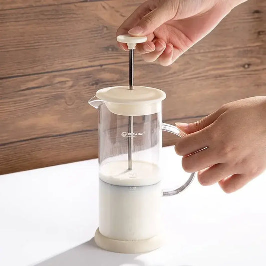 Modern cream glass french press coffee maker with plastic body and metal plunger serves as a hand foam mixer blender