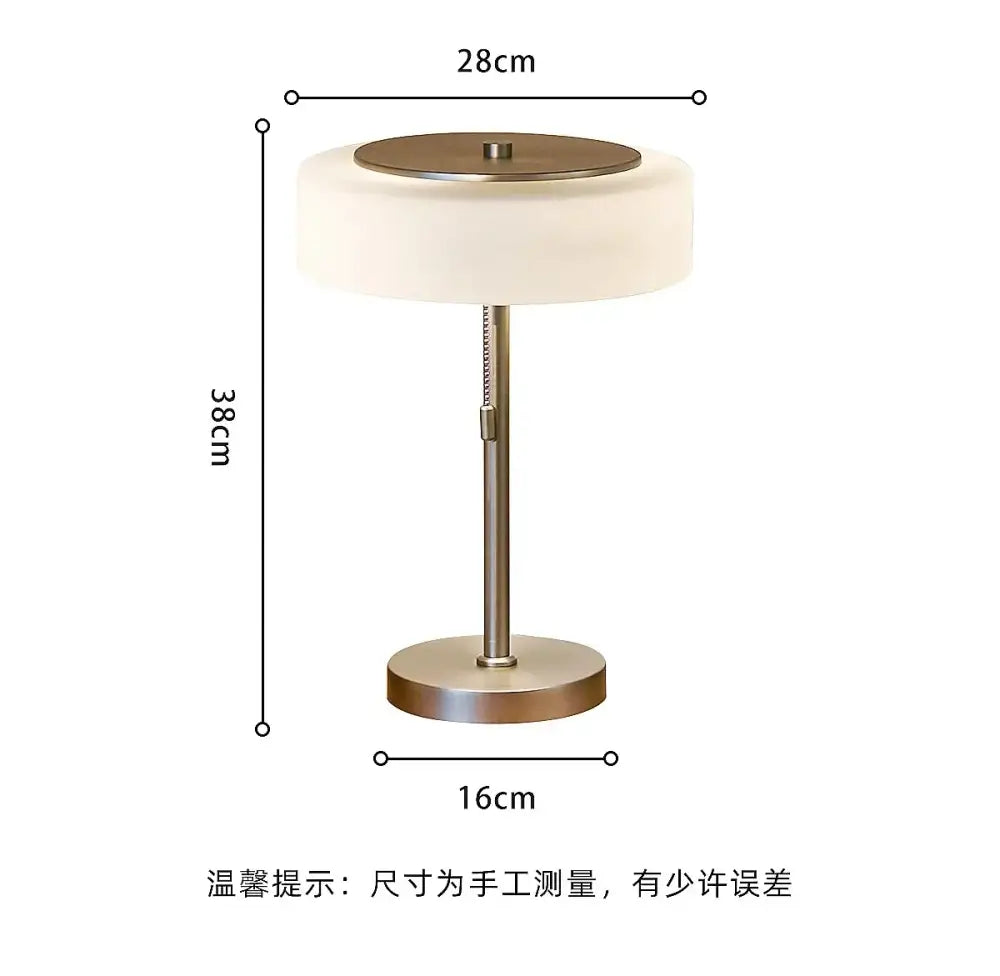 A sleek cream glass table lamp with a brushed brass base and frosted shade for modern decorbites decor