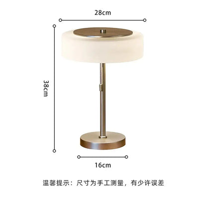 A sleek cream glass table lamp with a brushed brass base and frosted shade for modern decorbites decor