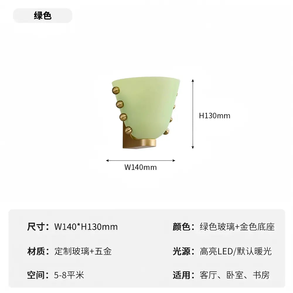 Modern cream glass wall lamp featuring a sleek green glass sconce with gold-toned metal decorbites cream glass accents