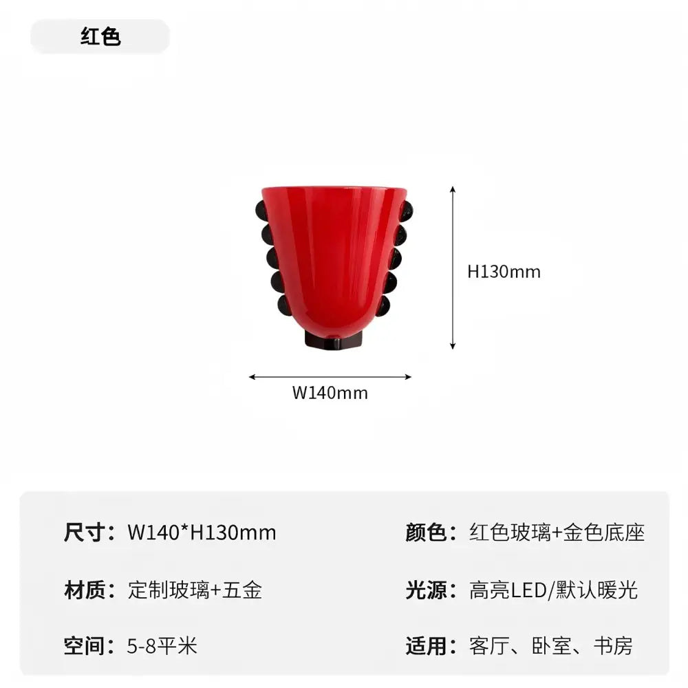 A vibrant red glass wall lamp with black spherical accents and gold base for decorbites cream glass wall lighting