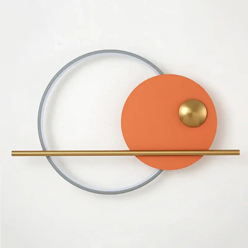 Modern cream and orange circular led wall lamps featuring a matte orange panel with brass knob and gold-toned rod