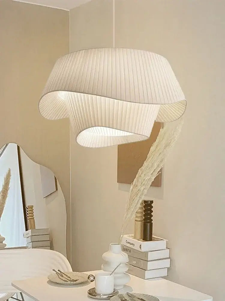 A modern off-white pleated pendant light with sculptural design in fabric by decorbites designer led for bedroom decor