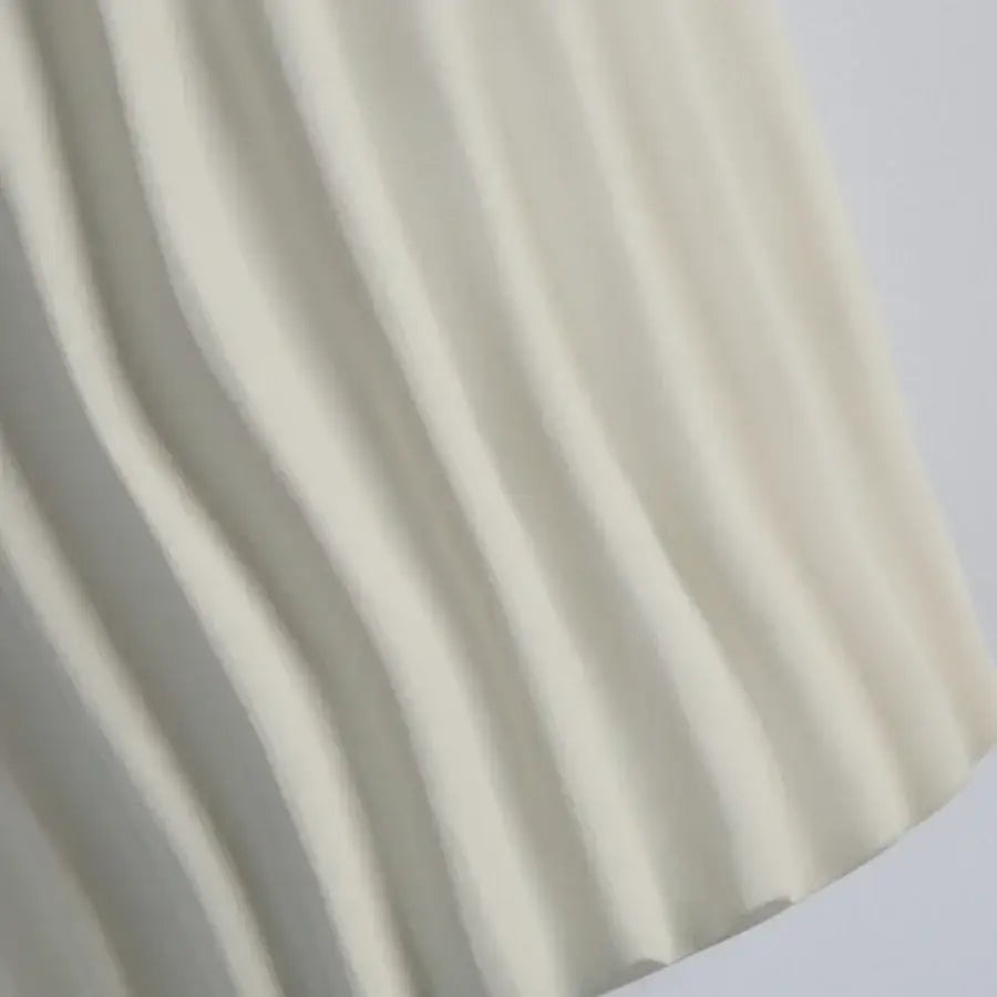 Modern cream ridged ceramic double led wall lamp with soft cream pleated fabric features gentle flowing folds