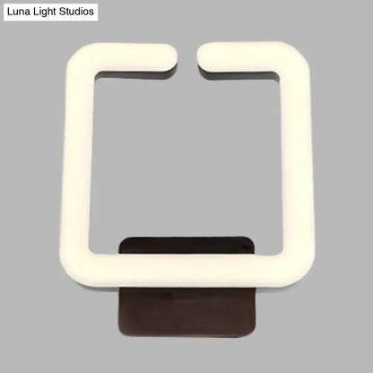 Modern cream square wall sconce with warm white direct wired electric light and dark brown base for natural light ambiance