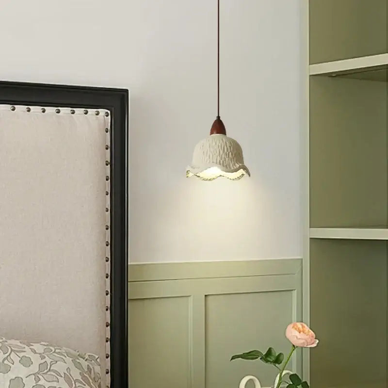 Modern cream textured ceramic pendant lamp with ruffled edge and dark brown wooden stem decorbites bud micro cement