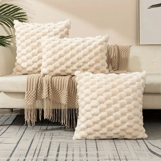 Cream-colored plush decorative pillow covers with textured raised pom pom pattern for living room use