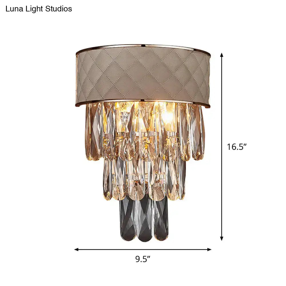 Modern cream wall lamp with quilted taupe fabric shade and crystal prism shade featuring clear and dark gray crystals