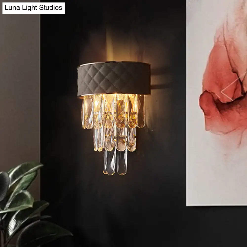 Modern indoor wall lamp with quilted black fabric and crystal prism shade for elegant bedroom lighting