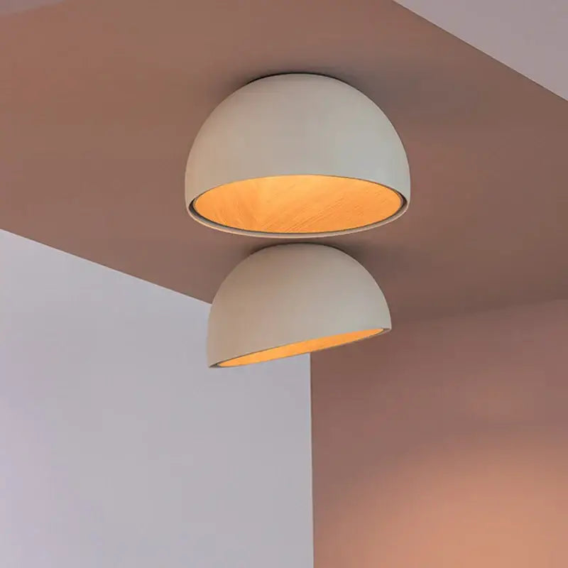 Two minimalist dome-shaped decorbites cream wind led ceiling chandelier lights with matte off-white exterior and warm amber interior
