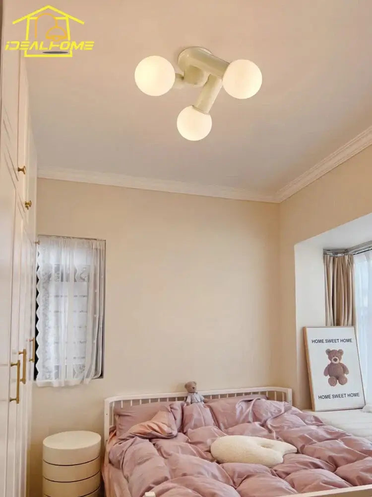 Cream wind led ceiling light with three cream-colored frosted glass globe bulbs for modern bedroom lighting