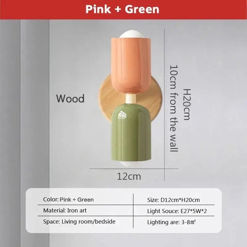 Modern cream zipper wooden wall lamp with pink and green shades mounted on circular wooden base for bedroom illumination