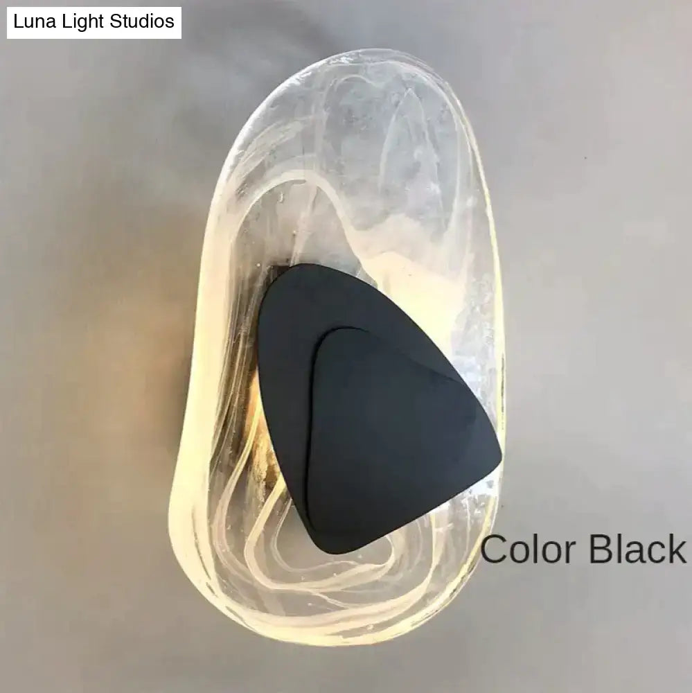 Black triangular insole inside transparent gel insert showcasing modern creative minimalist glass wall lamp features