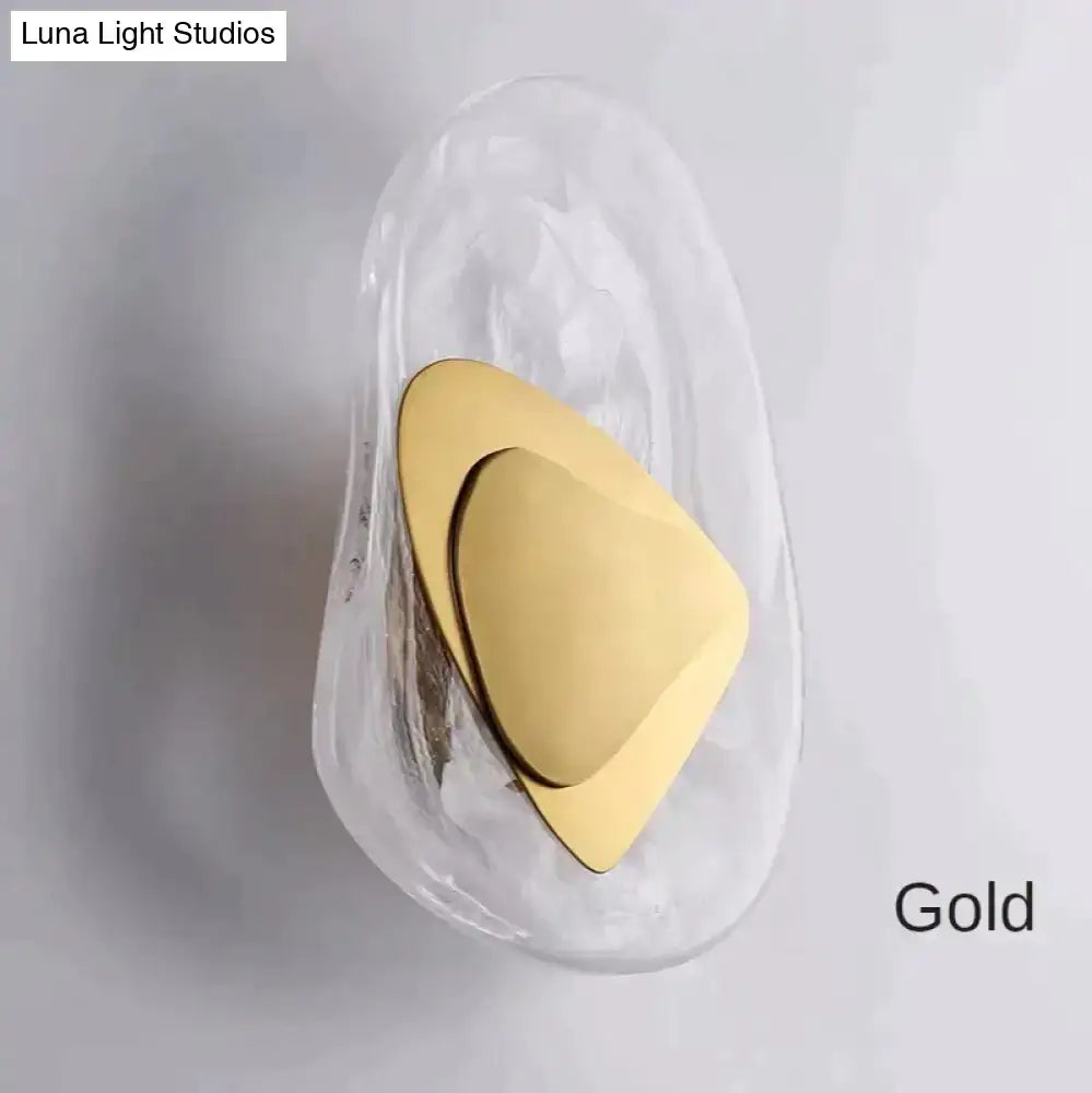 Modern creative minimalist gold-toned triangular wall sconce in translucent glass for bedroom bedside lighting
