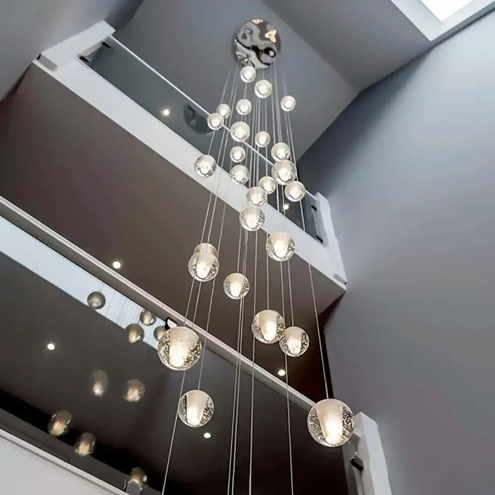 A modern crystal ball led chandelier with clear glass orbs and metallic yin-yang fixture for living room decorbites crystal ball