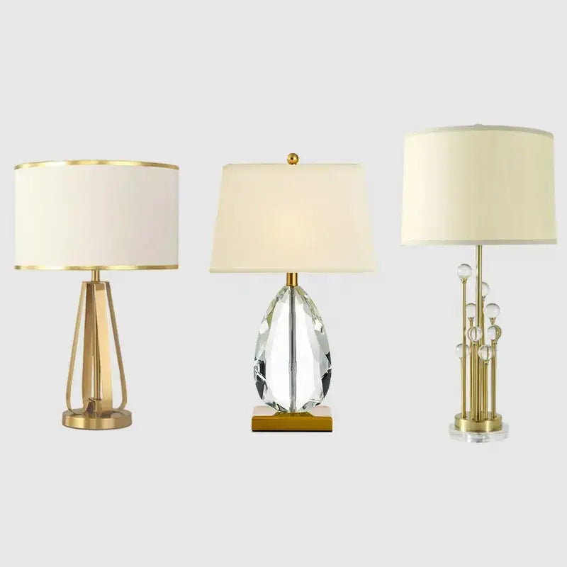 Three modern decorbites crystal bedside lamps with white fabric shades and gold-toned bases for bedroom light decor