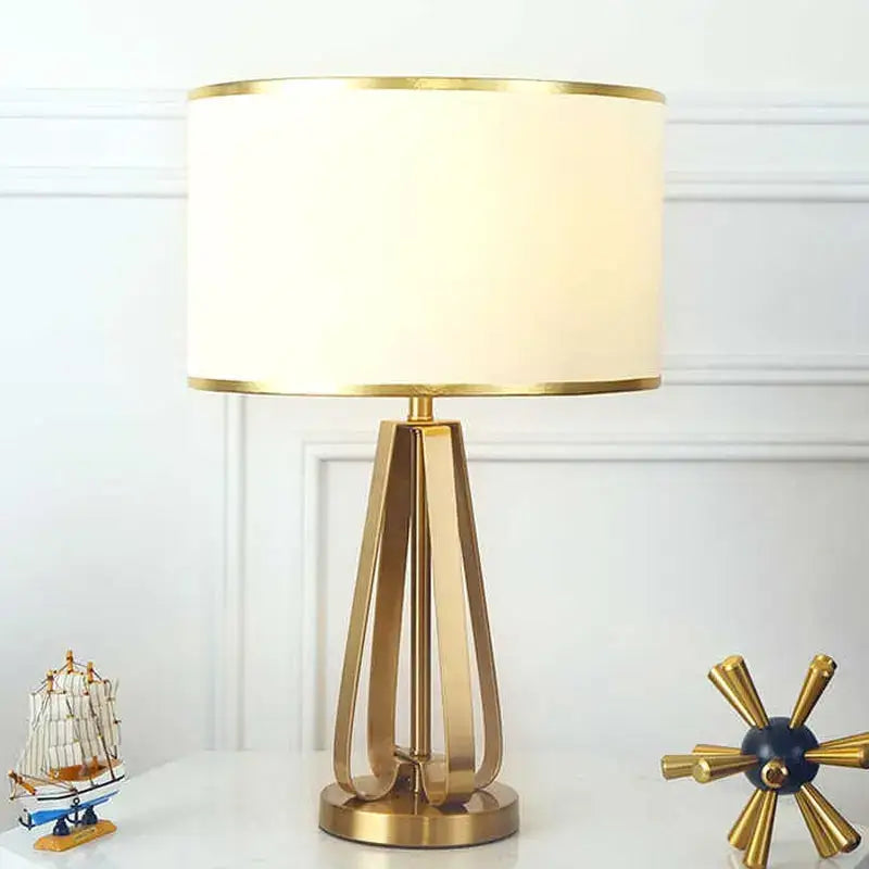 Modern decorbites crystal bedside lamp with gold metal base and cylindrical off-white fabric shade for bedroom light