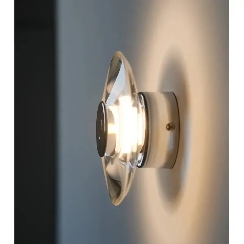 Modern crystal bedside wall lamp with clear glass dome and chrome base emitting warm light for bedroom decorbites wall lamp
