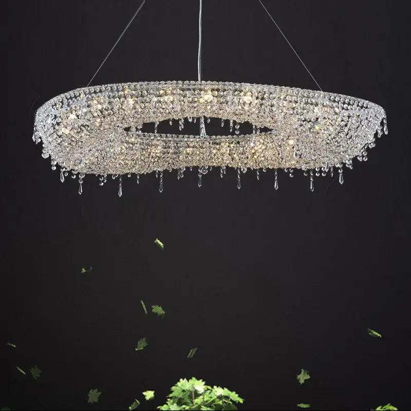 Modern crystal bird nest chandelier featuring multi tiered dangling beads and crystals radiating light in dining room