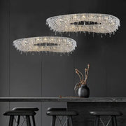 Two elegant circular crystal bird nest chandeliers with cascading droplets for modern dining room lighting