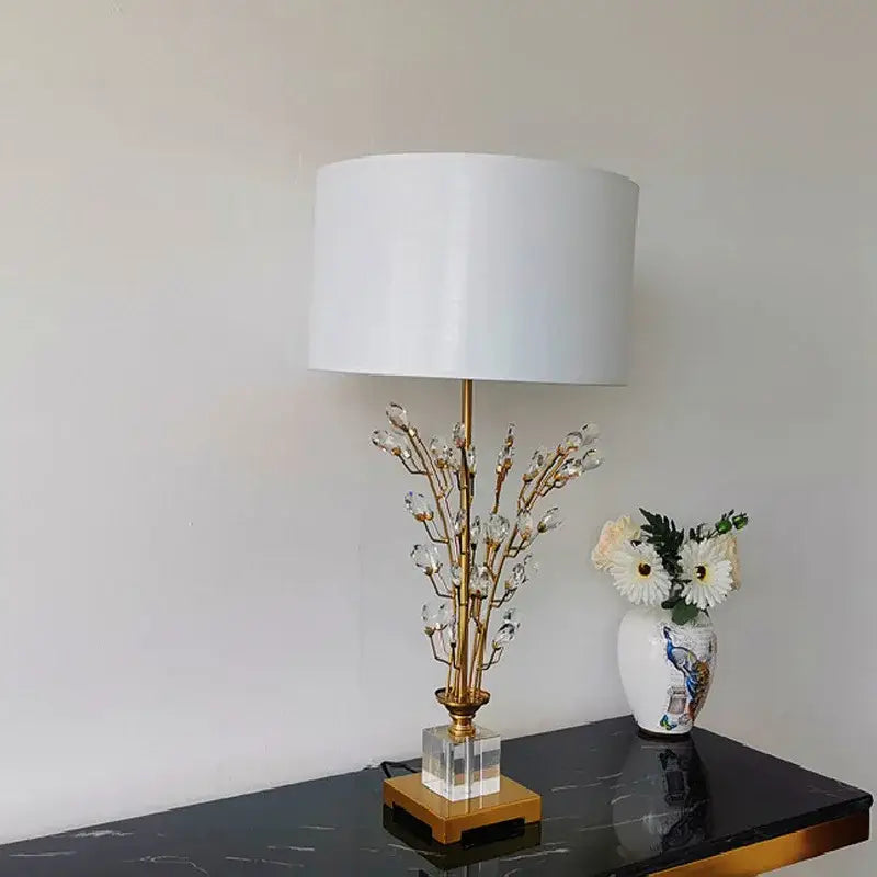 Elegant gold-toned decorbites crystal branch table lamp with white cylindrical shade and clear acrylic base for bedroom decor